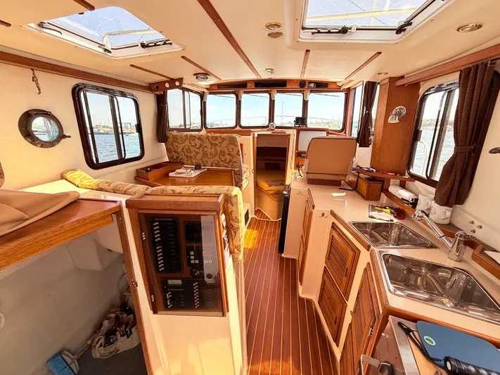 Sam Mcgee Yacht Photos Pics Interior of 2009 Ranger Tugs R-29 boat, featuring wood accents and spacious layout.