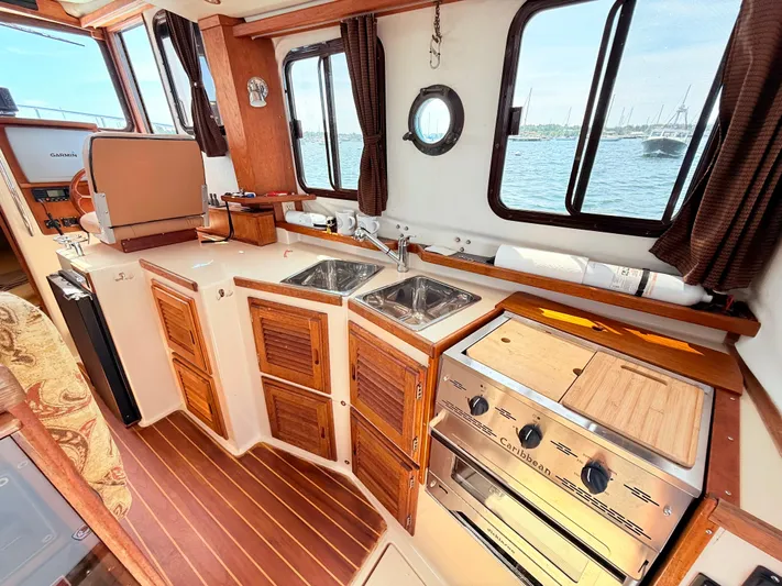Sam Mcgee Yacht Photos Pics Cozy 2009 Ranger Tugs R-29 galley with wood accents, dual sinks, and ocean view.