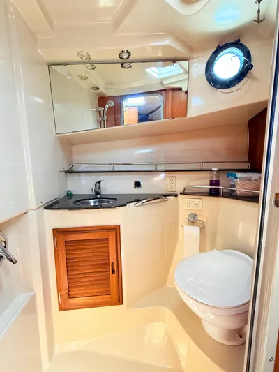 Sam Mcgee Yacht Photos Pics 2009 Ranger Tugs R-29 boat bathroom with sink, toilet, mirror, and porthole window.