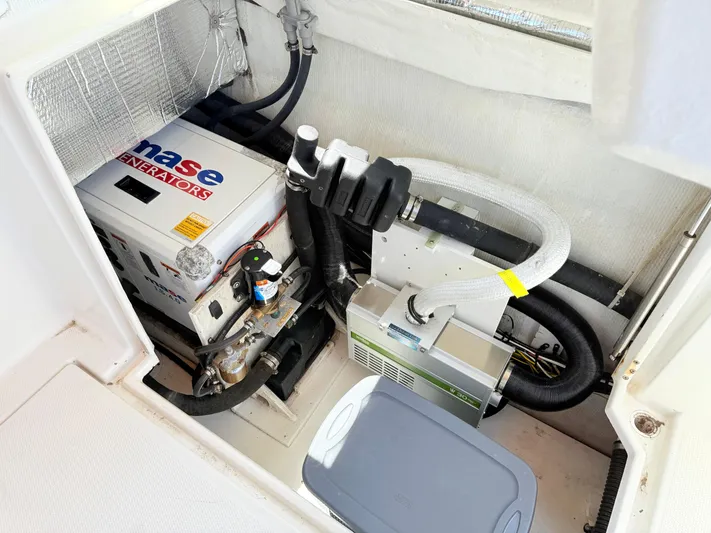 Sam Mcgee Yacht Photos Pics Engine compartment of a 2009 Ranger Tugs R-29 with generator and mechanical components.