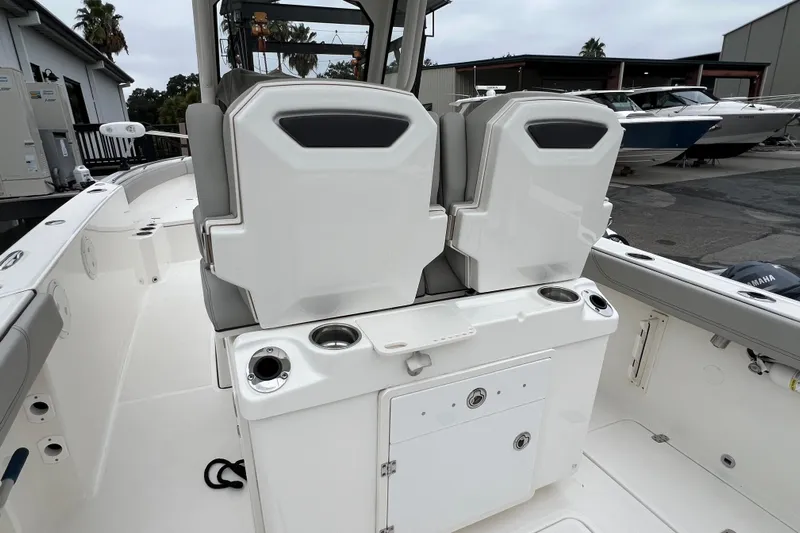 Happy Hours Yacht Photos Pics 2023 Pursuit S 268 Sport boat interior with dual seats and storage compartments.