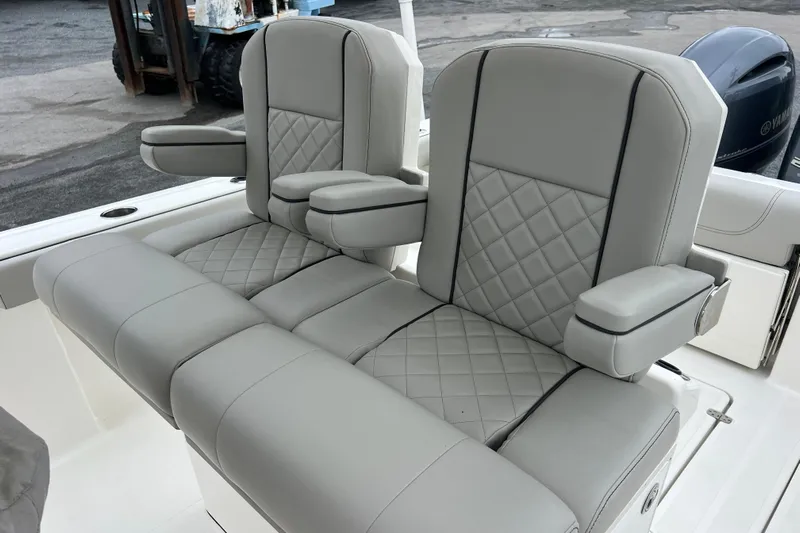 Happy Hours Yacht Photos Pics 2023 Pursuit S 268 Sport boat seats with diamond-stitched gray upholstery and armrests.