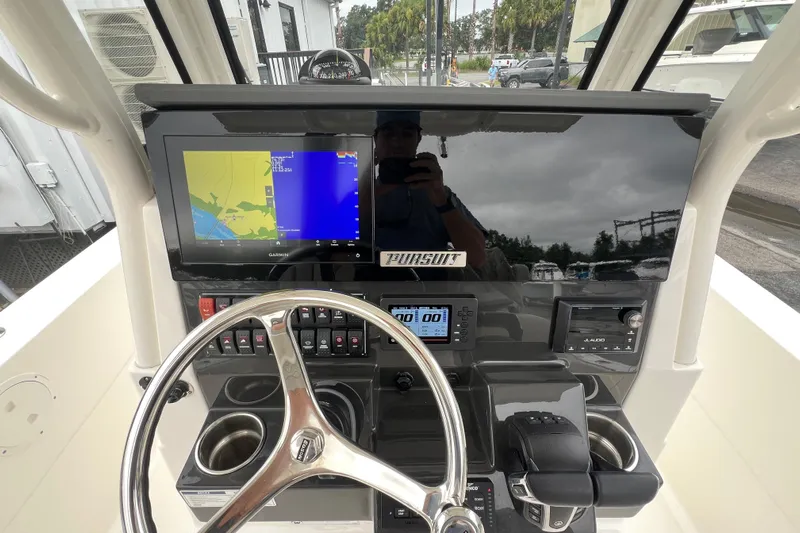 Happy Hours Yacht Photos Pics 2023 Pursuit S 268 Sport boat dashboard with navigation display and controls.