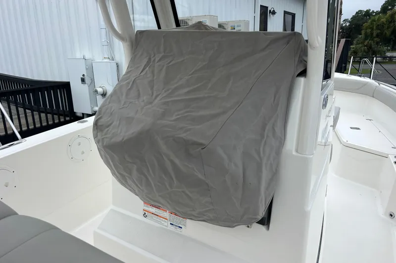 Happy Hours Yacht Photos Pics 2023 Pursuit S 268 Sport boat with covered console, docked outdoors.