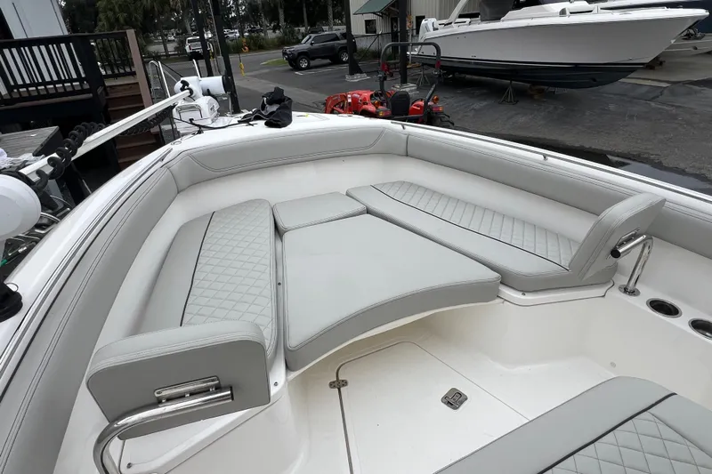 Happy Hours Yacht Photos Pics 2023 Pursuit S 268 Sport boat interior with cushioned seating and modern design.