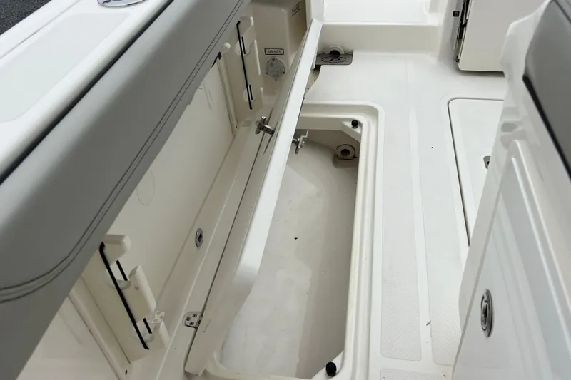 Happy Hours Yacht Photos Pics 2023 Pursuit S 268 Sport boat interior storage compartment, open and empty.
