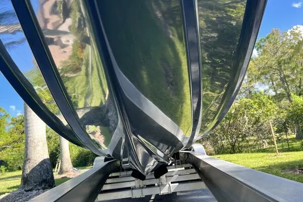  Yacht Photos Pics 1996 Formula 382 SR1 boat hull on trailer, reflecting greenery and blue sky.