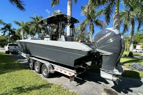  Yacht Photos Pics 1996 Formula 382 SR1 boat on trailer with Mercury outboard, surrounded by palm trees.