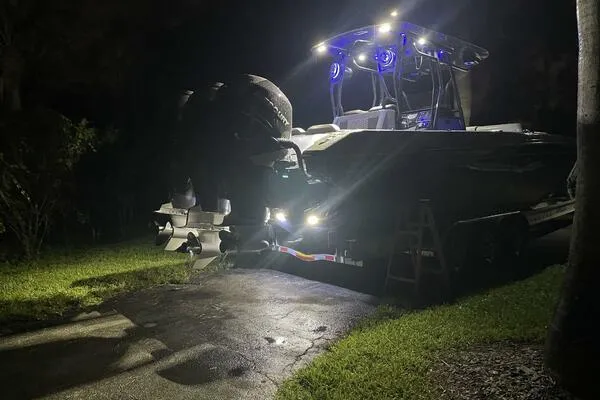  Yacht Photos Pics 1996 Formula 382 SR1 boat illuminated at night, showcasing powerful engines and sleek design.