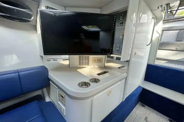  Yacht Photos Pics Interior of a 1996 Formula 382 SR1 boat with TV and seating area.