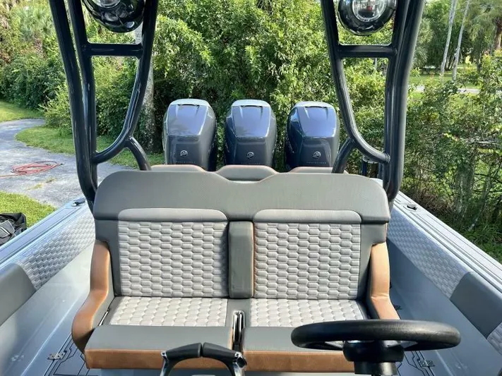  Yacht Photos Pics 1996 Formula 382 SR1 boat interior with triple outboard motors and cushioned seating.