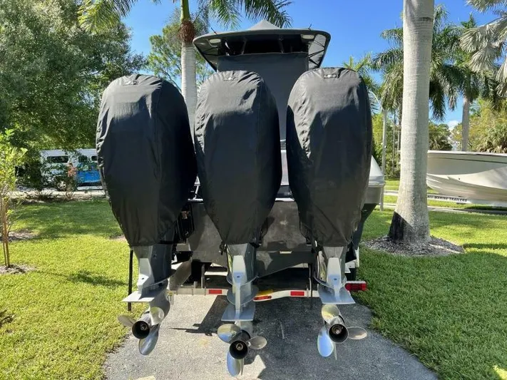  Yacht Photos Pics 1996 Formula 382 SR1 boat with triple outboard motors covered, parked outdoors.