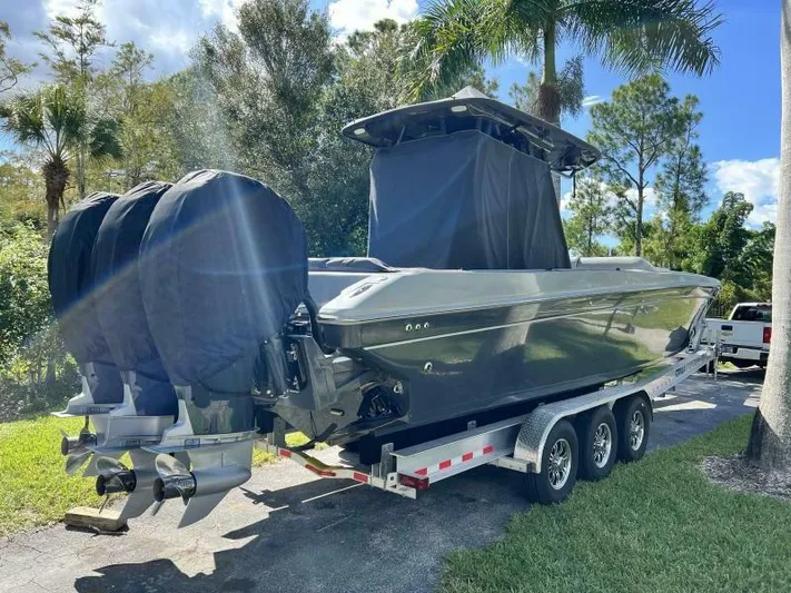  Yacht Photos Pics 1996 Formula 382 SR1 boat on trailer with triple outboard motors, parked outdoors.