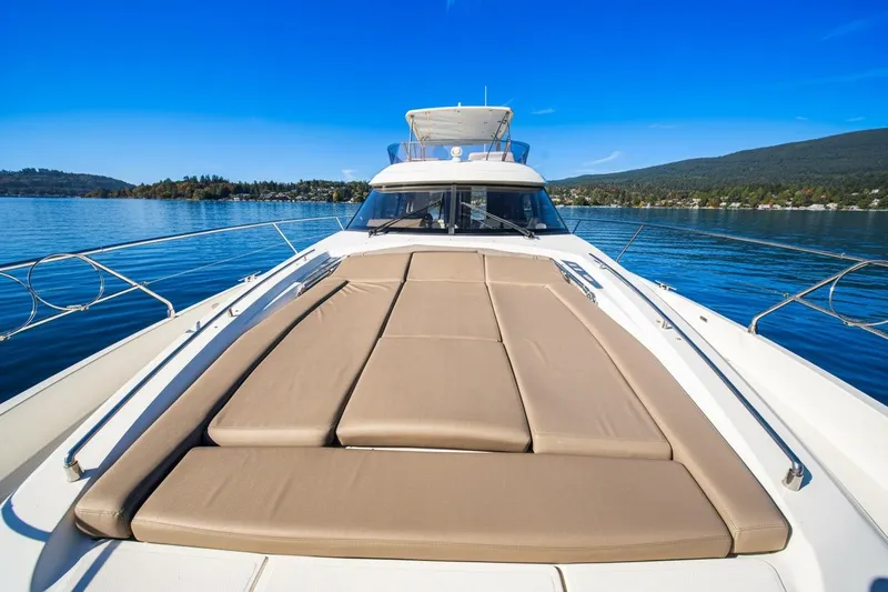 Luna Maris Yacht Photos Pics Prestige 550 Flybridge 2016 yacht on calm water with sunbathing deck.