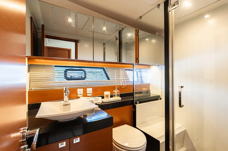 Luna Maris Yacht Photos Pics Luxurious bathroom in 2016 Prestige 550 Flybridge yacht with modern fixtures and elegant design.