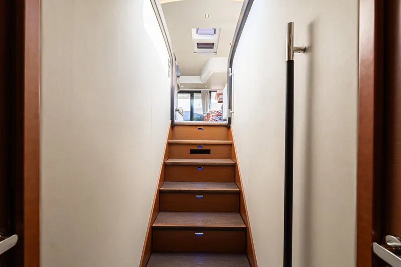 Luna Maris Yacht Photos Pics Staircase inside 2016 Prestige 550 Flybridge yacht, leading to upper deck with modern design.