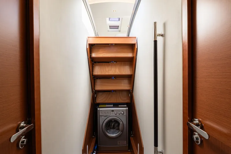 Luna Maris Yacht Photos Pics Laundry area with washing machine on 2016 Prestige 550 Flybridge yacht.