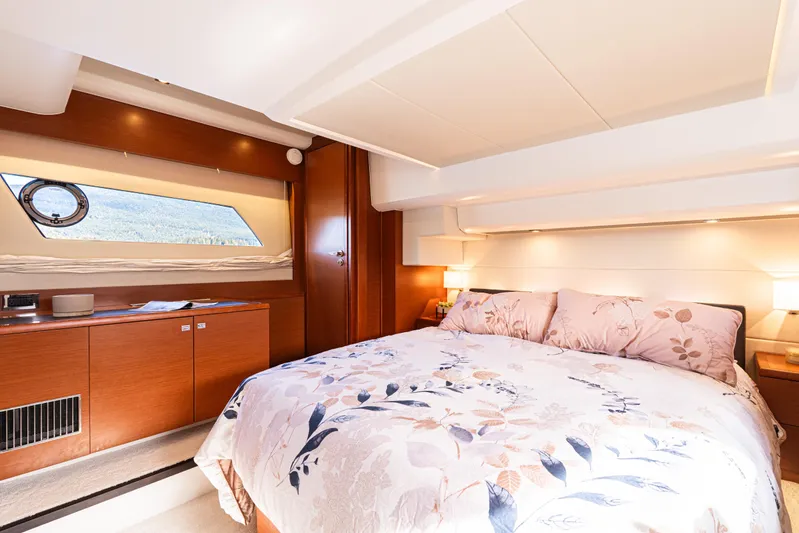Luna Maris Yacht Photos Pics Luxurious bedroom interior of 2016 Prestige 550 Flybridge yacht with elegant bedding and wood finishes.