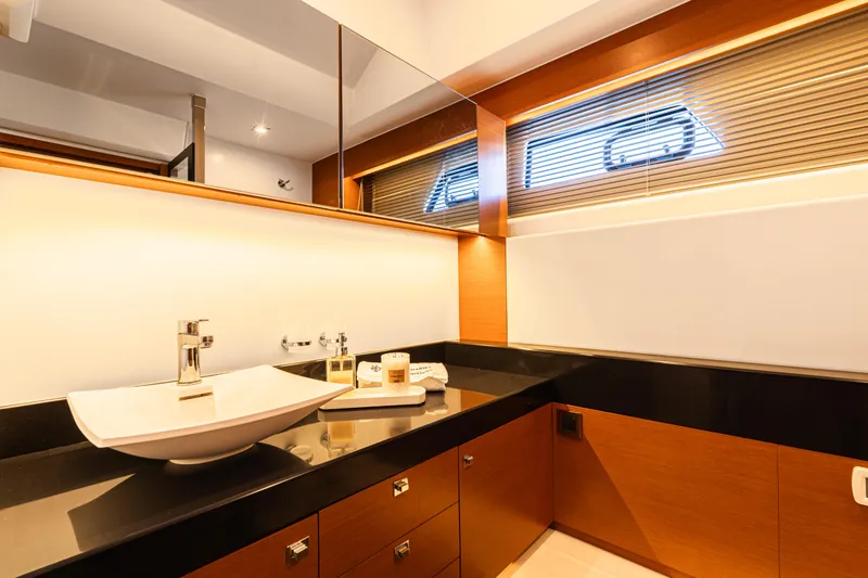 Luna Maris Yacht Photos Pics Luxurious bathroom on 2016 Prestige 550 Flybridge yacht with modern sink and elegant design.
