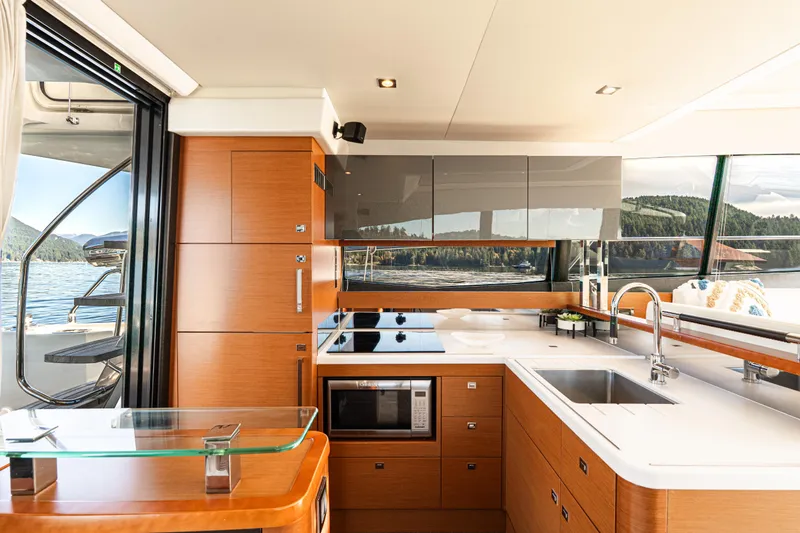 Luna Maris Yacht Photos Pics Luxurious kitchen interior of 2016 Prestige 550 Flybridge yacht with modern amenities.
