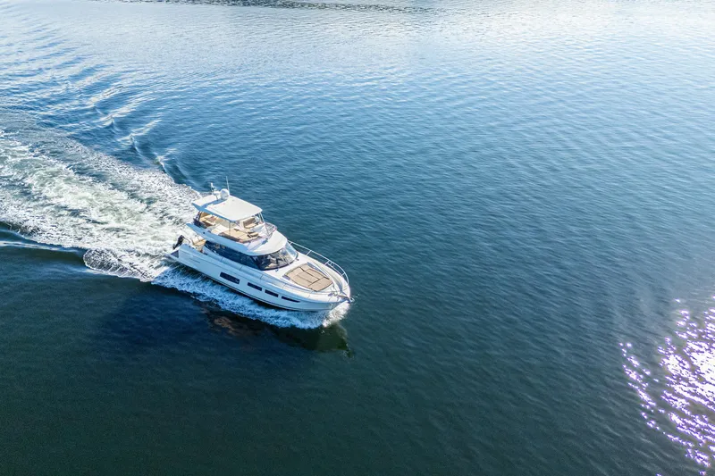Luna Maris Yacht Photos Pics Aerial view of 2016 Prestige 550 Flybridge yacht cruising on open water.