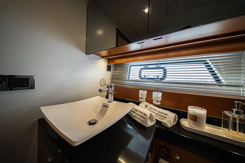 Luna Maris Yacht Photos Pics Luxurious bathroom interior of 2016 Prestige 550 Flybridge yacht with modern sink and accessories.