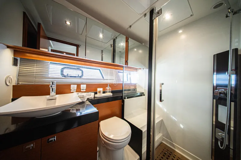 Luna Maris Yacht Photos Pics Luxurious bathroom in 2016 Prestige 550 Flybridge yacht with modern fixtures and elegant design.