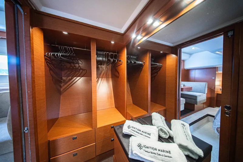 Luna Maris Yacht Photos Pics Luxurious 2016 Prestige 550 Flybridge yacht interior with spacious wooden closet and elegant seating area.
