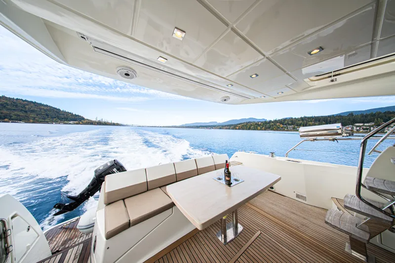 Luna Maris Yacht Photos Pics Prestige 550 Flybridge 2016 yacht cruising with scenic water view and elegant deck seating.