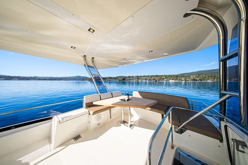 Luna Maris Yacht Photos Pics Prestige 550 Flybridge 2016 yacht with spacious deck, scenic water view, and comfortable seating.