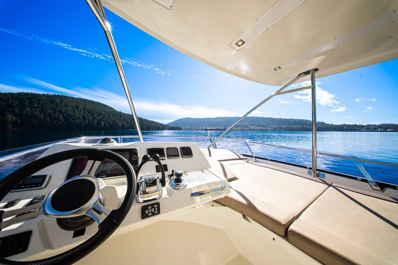 Luna Maris Yacht Photos Pics Prestige 550 Flybridge 2016 yacht helm with scenic ocean view and clear blue sky.