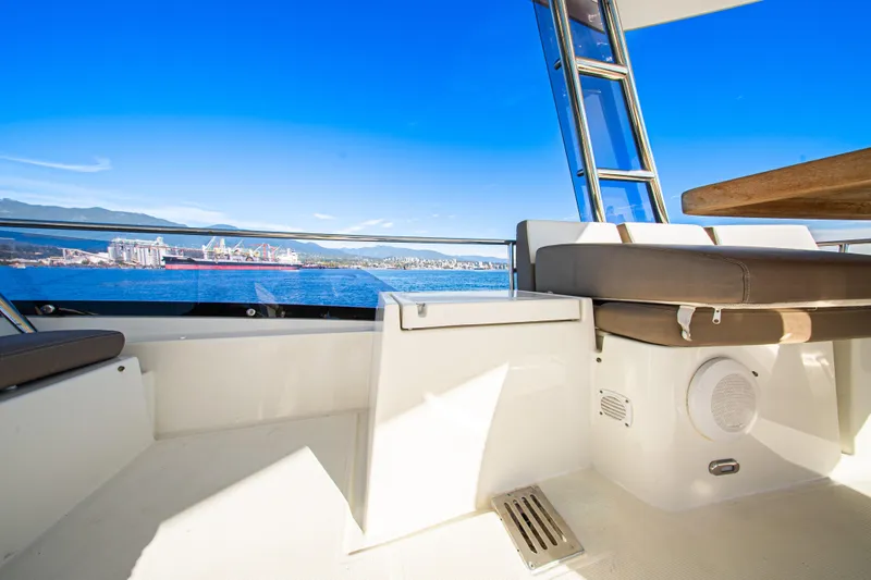 Luna Maris Yacht Photos Pics 2016 Prestige 550 Flybridge yacht deck with ocean and cityscape view.