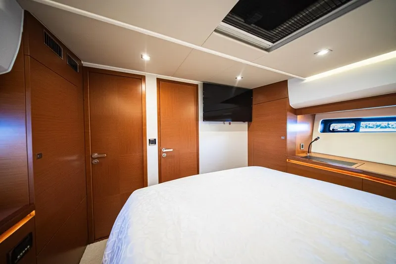 Luna Maris Yacht Photos Pics Luxurious cabin interior of 2016 Prestige 550 Flybridge yacht with modern wood finishes.