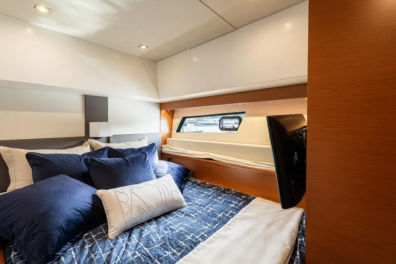 Luna Maris Yacht Photos Pics Luxurious bedroom interior of 2016 Prestige 550 Flybridge yacht with elegant bedding and window view.