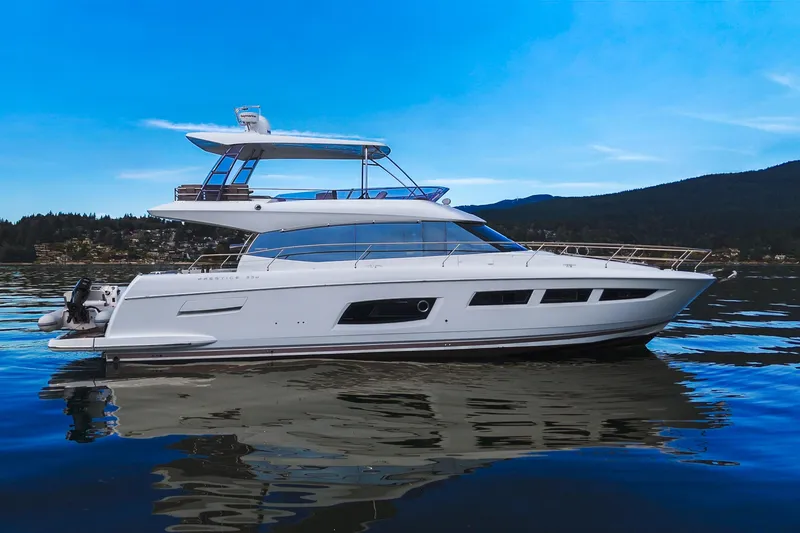 Luna Maris Yacht Photos Pics 2016 Prestige 550 yacht on calm water with scenic mountain backdrop.