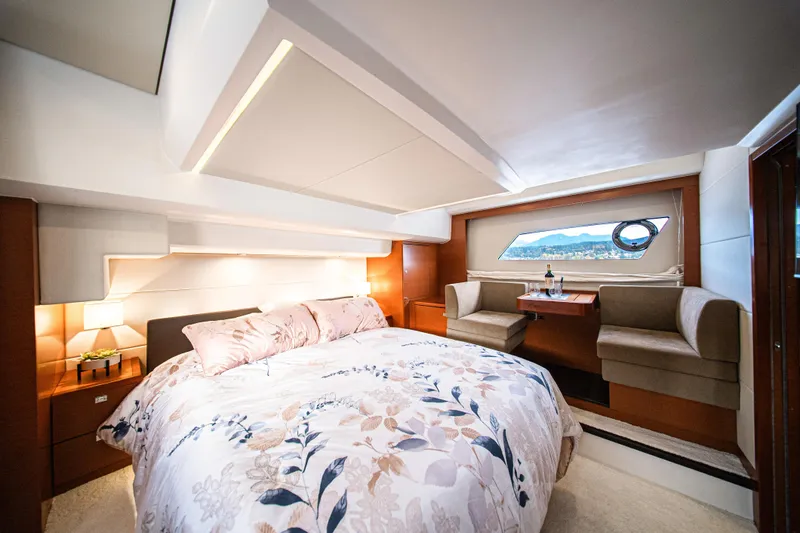 Luna Maris Yacht Photos Pics Luxurious bedroom interior of 2016 Prestige 550 yacht with elegant decor and scenic window view.