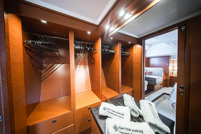 Luna Maris Yacht Photos Pics Luxurious wooden closet interior on a 2016 Prestige 550 yacht with hangers and towels.