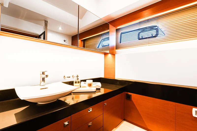 Luna Maris Yacht Photos Pics Luxurious bathroom interior on a 2016 Prestige 550 yacht, featuring modern sink and wooden cabinetry.