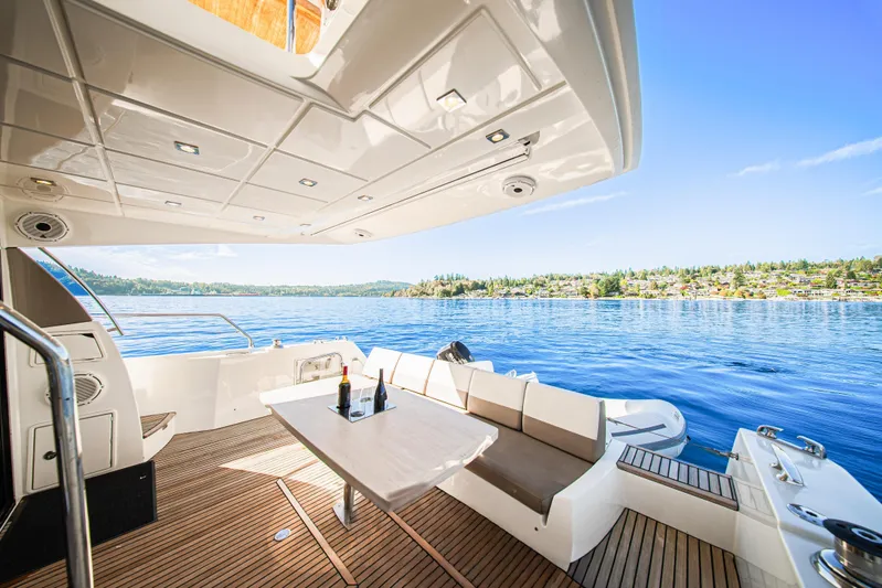 Luna Maris Yacht Photos Pics Luxurious 2016 Prestige 550 yacht deck with scenic waterfront view.