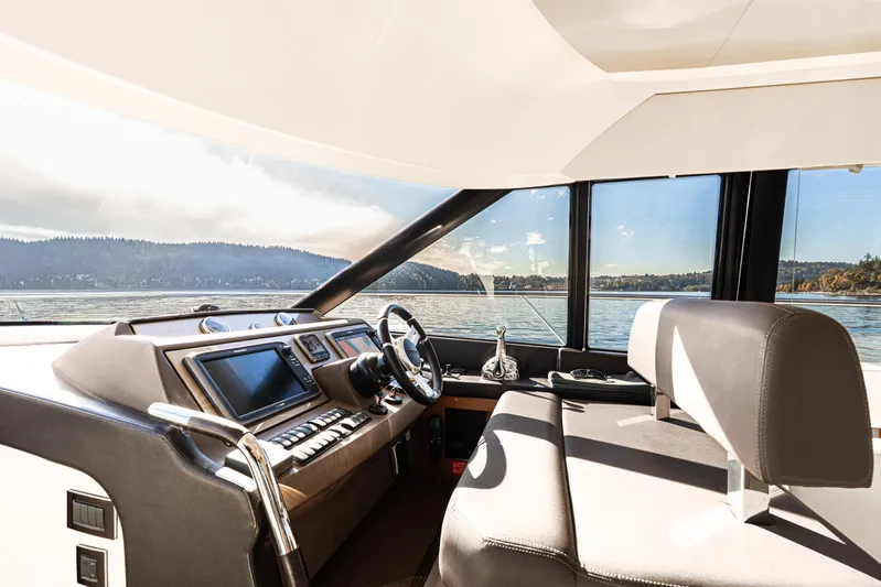Luna Maris Yacht Photos Pics Luxurious 2016 Prestige 550 yacht cockpit with modern controls and scenic water view.