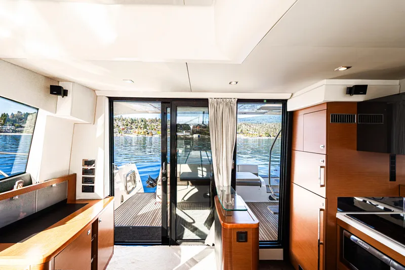Luna Maris Yacht Photos Pics Interior view of 2016 Prestige 550 yacht with modern design and scenic water backdrop.