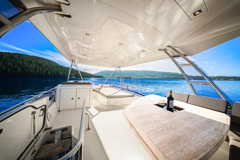 Luna Maris Yacht Photos Pics Luxurious 2016 Prestige 550 yacht interior with scenic lake view and elegant seating area.