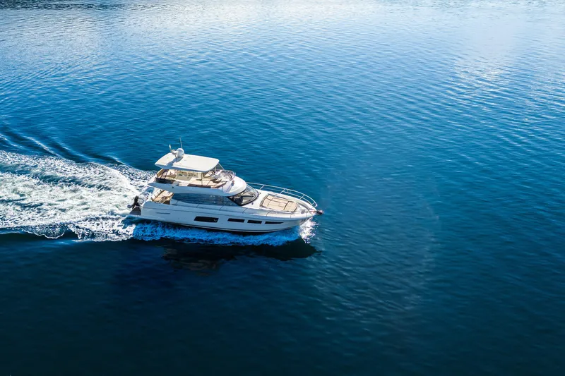 Luna Maris Yacht Photos Pics Aerial view of 2016 Prestige 550 yacht cruising on calm blue waters.