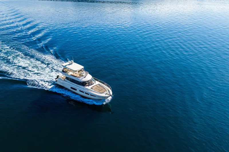 Luna Maris Yacht Photos Pics Aerial view of 2016 Prestige 550 yacht cruising on open blue water.