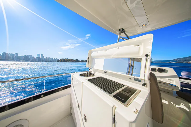 Luna Maris Yacht Photos Pics Luxurious 2016 Prestige 550 yacht with outdoor kitchen, city skyline, and ocean view.