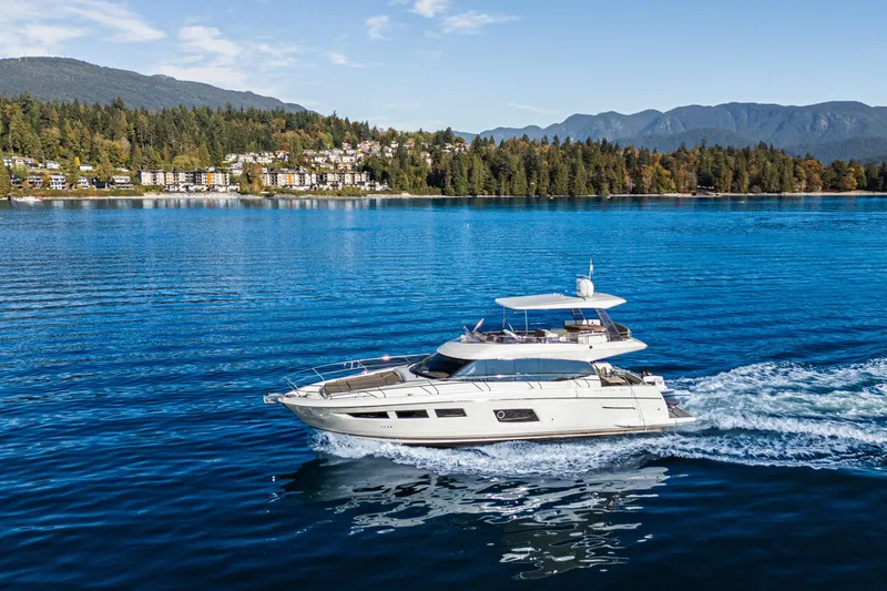 Luna Maris Yacht Photos Pics Luxury 2016 Prestige 550 yacht cruising on a scenic lake with forested hills.