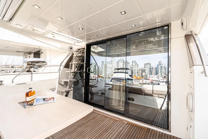 Luna Maris Yacht Photos Pics Luxurious 2016 Prestige 550 yacht interior with city skyline view through glass doors.