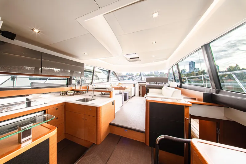 Luna Maris Yacht Photos Pics Luxurious interior of 2016 Prestige 550 yacht with modern kitchen and seating area.