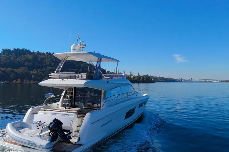 Luna Maris Yacht Photos Pics Luxurious 2016 Prestige 550 yacht cruising on a serene blue waterway.