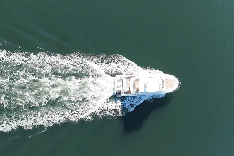 Luna Maris Yacht Photos Pics Aerial view of 2016 Prestige 550 yacht cruising on open water.
